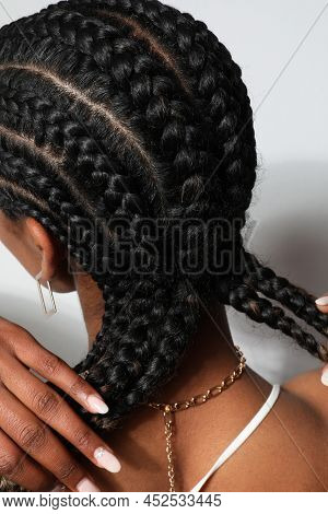 Vertical Close-up Of African Woman With Braids Posing On White Background.