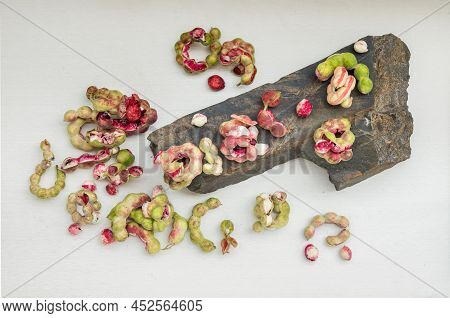 Group Of Manila Tamarind Fruit Or Pithecellobium Dulce Is Another Type Of Thai Herb On Black Rock On