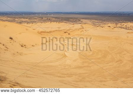 Sarykum Dune. Dagestan, Russia. A Unique Sandy Mountain In The Caucasus On A Cloudy Day. Grass Grows