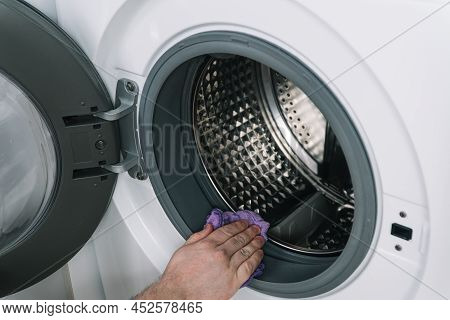 Mens Hand Clean The Washing Machine. Detail Cleaning Concept Of Washing Machine. Stainless Drum Insi