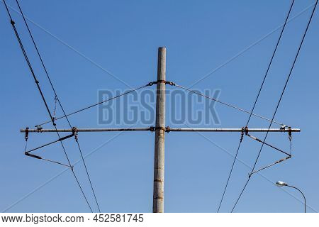 An Electric Pole On A Blue Sky Background.