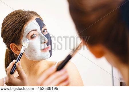Woman Cleaning Skin Face, Using Green Mud And Carbo Black Mask. Girl Taking Care Of Oily Complexion.