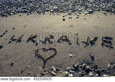 The Inscription Of The Name Of The Country Ukraine On The Sand Of The Beach On The Tyrrhenian Sea On