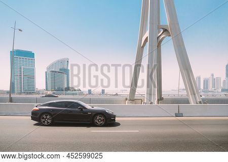 Dubai, Uae, United Arab Emirates - May 28, 2021: Black Porsche Panamera Car Moving In City Street. P