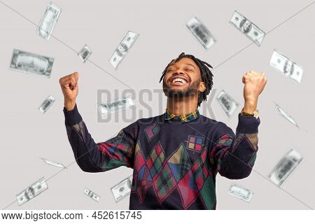 Money Rain, Winner And Rich. Hurray. Satisfied Happy Man With Dreadlocks Rising Hands Up With Toothy