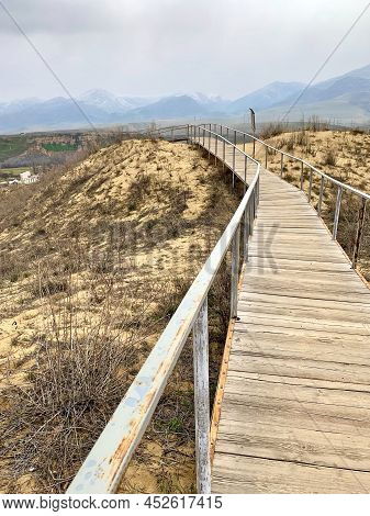 The Staircase Rises To A Sandy Dune. Climbing To The Top In The Desert. Sarykum Dune. Dagestan, Russ