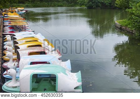 Swan Tourists Boats Moored To A Wooden Dock On A Small Pond In The Jinshan Temple Scenic Area In Zhe