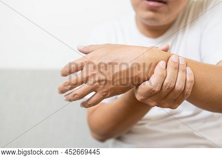 Asian Middle-aged Man Suffering From Gout,rheumatoid,chronic Arthritis With Pain,injury Wrist Bones,