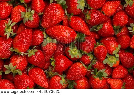 Background Of Fresh Ripe Red Scattered Strawberries