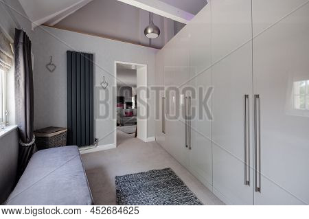 Fen Drayton, England - June 7 2018: Furnished Dressing Room With Built In Wardrobes And Open Doorway
