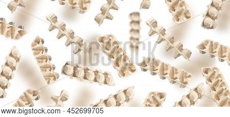 An Egg Packaging Made Of Recycled Cardboard On A White Background. An Egg Carton For Recycling Flies
