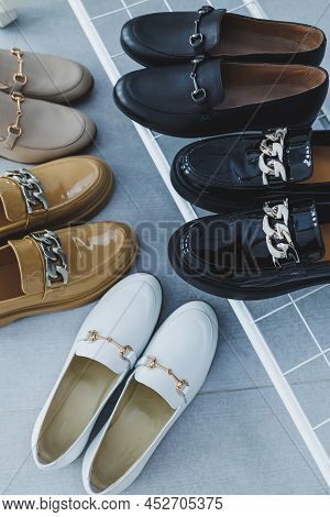 Lots Of Women's Shoes On The Floor, Different Leather Shoes. New Women's Shoes Scattered On The Floo