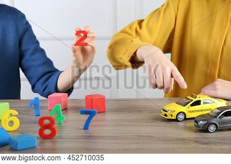 Aba Therapist And Girl At Wooden Table, Closeup