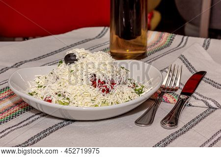 Traditional Bulgarian Shopska Salad Is On A Plate