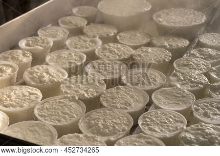 Process Of Making Fresh White Soft Ricotta Whey Cheese On Small Cheese Farm In Parma, Italy