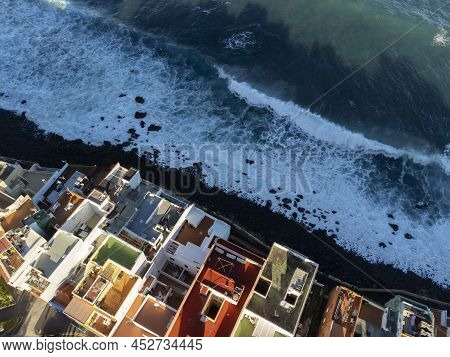 Aerial View On Colorful Houses And Black Lava Rocks In Small Village Punta Brava Near Puerto De La C