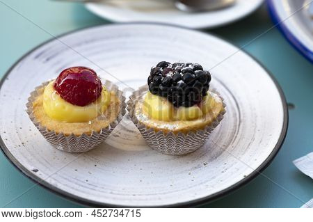 Mini Fruit Italian Cupcakes With Fresh Berries On Board