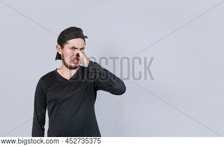 A Man With Covering His Nose, A Guy With A Face Of Unpleasant Odors, Concept Of Bad Smells