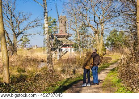 Gifhorn, Germany - March 20, 2022: Couple Enjoying The View Of The Windmills In Gifhorn, Germany