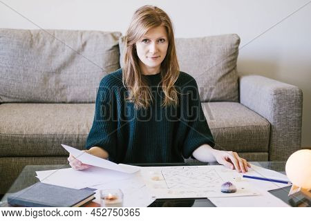 Woman Astrologist Conducts A Consultation At Home.