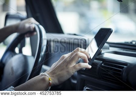 Close Up Of Woman Hand Setting The Gps Online Navigator On The Phone While Drive - People And Travel