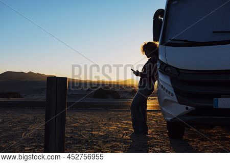 Woman In Silhouette Against Sunset Beautiful Light. Travel People With Camper Camping Car Van For Su