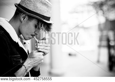 Black And White Young Boy Teenager Portrait Lighting A Cigarette To Smoke In Youth Age - Un Healthy 