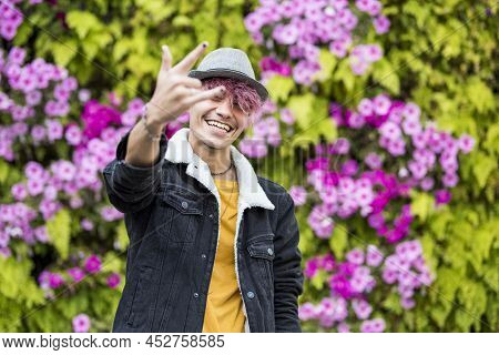Happy Young Boy Man Teenager Enjoy And Smile In Portrait With Violet Flowers And Hair Background - C