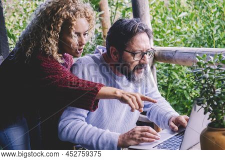 Adult Couple Use And Look At Display Laptop Worried And Scared. Concept Of Man And Woman Online Busi