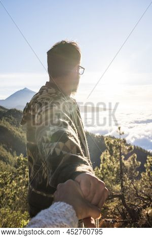 Man Holding Hands Of Her Wife And Admiring Scenic Mountain Landscape On Hiking Outdoor Tour. Couple 