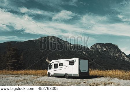 Modern Motorhome Camp Site In The Mountain Nature. Concept Of Travel And Alternative Transport Vacat