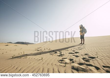 One Man Standing On The Sand Desert Dunes With Backpack Looking Far - Climate Change Arid No Water F