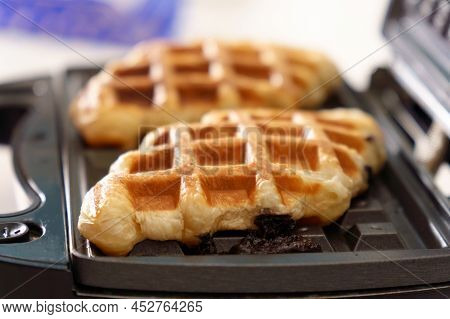 Croffle Croissant And Waffle. Soft And Layered Croissant Dough Is Squeezed With A Waffle Iron And Fr