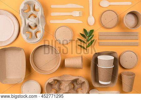 Flat Lay Composition With Eco-friendly Tableware - Kraft Paper Utensils On Orange Background. Street