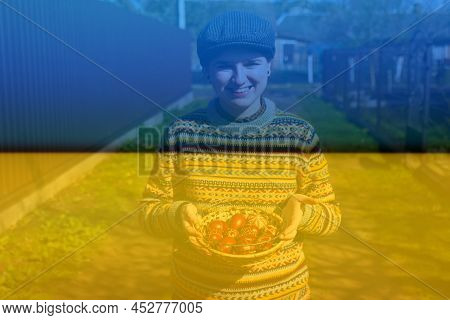 Defocus Ukrainian Young Smiling Woman In Hat Holding Plate Of Collection Of Red Egg On Nature Backgr