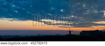 This Beautiful Mountain Mill Is Located In Wannegem-lede Belgium, With The Rise Of The Sun And  Clou