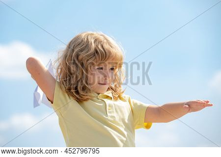 Kid Dreaming And Plays With A Toy Plane In The Park. Dreams Of Travel. Development, Growth, Dreams A