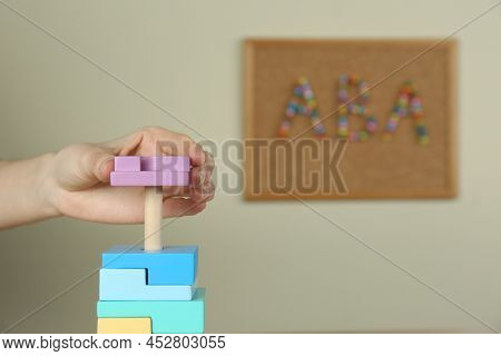 Child Playing With Toy Pyramid Indoors, Closeup. Aba Therapy Concept