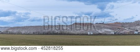Giant Spreader Or Absetzer Machinery. A Large Dumper On A Landfill With Potash Ore. Extracting And M