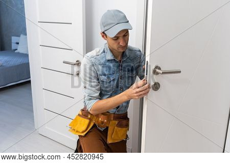 Handyman Installing And Fixing Automatic Door Closer. Maintenance And Service