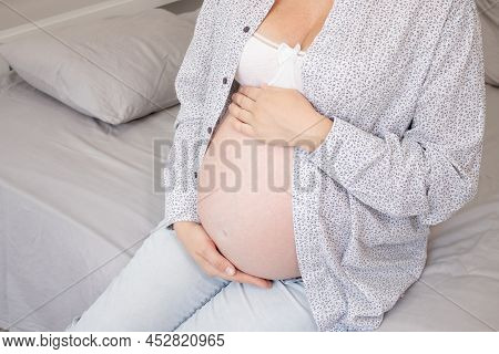 Mother To Be On Bedchamber. Pretty Woman With Big Tummy. Expecting Parent Mother. Happy Motherhood.