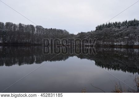Cold And Icy Holzmaar With A Mirror Calm Surface