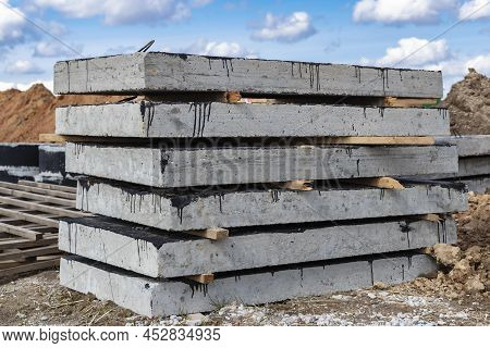 Reinforced Concrete Slabs At A Construction Site Against A Blue Cloudy Sky And Earth. Folded Plates 