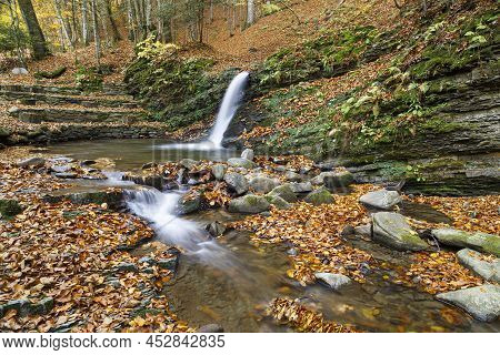Autumn Nature Landscape With Leaf Fall On Waterfall  Krutylo In Mountain Gorge On Turichka River. Lu