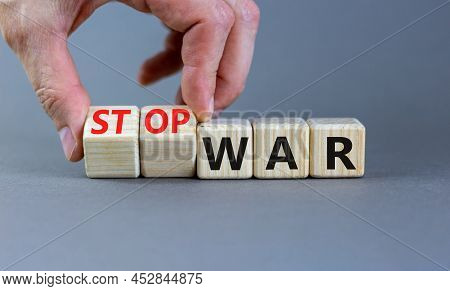 Stop War Symbol. Businessman Turns Cubes And Changes Concept Words War To Stop War. Beautiful Grey T