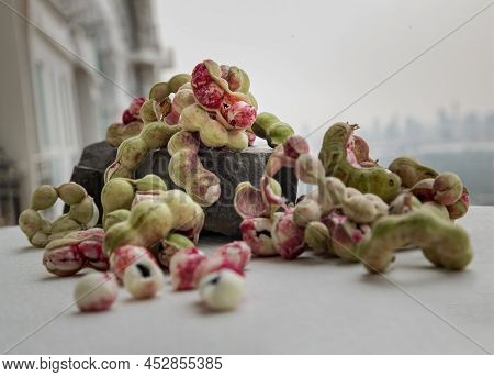 Group Of Manila Tamarind Fruit Or Pithecellobium Dulce Is Another Type Of Thai Herb On Black Rock On