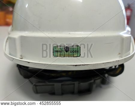 Malaysia, 14 April 2022: White Safety Helmet With Sirim And Dosh Stickers.