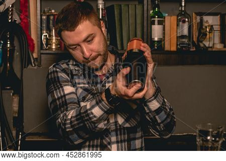 Bartender Stirring Ingredients For Refreshing Cocktail In Shaker
