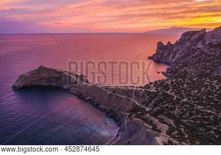 Novyi Svit, Crimea, Sudak. Aerial View Of Cape Kapchik During Beautiful Sunset. Black Sea