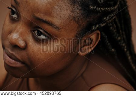 Close-up Of African Woman Face Looking Up With Blank Expression